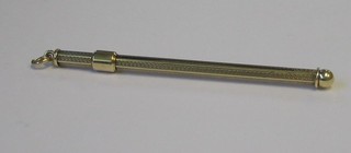 A gold swizzle stick