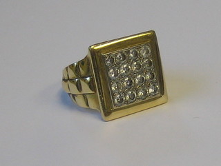 A gentleman's 18ct gold square dress ring set 16 diamonds with Rolex style strap decoration to the side (approx 1 1/2ct)