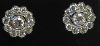 A pair of lady's 18ct gold cluster earrings set a large diamond to the centre surrounded by 10 diamonds (approx 1.35 ct)