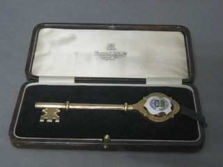 A silver gilt and enamel presentation key, presented to Mrs A R C Gordon on the occasion of opening Cross Car PE School 9 July 1931, cased