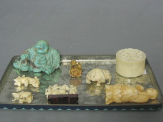 A circular carved ivory trinket box and cover 1 1/2", a small ivory figure of a Deity 3", 5 other figures and a green figure of a seated Buddha 3"
