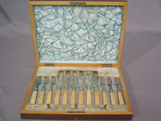 A set of 6 silver plated fruit knives and forks contained in a walnut canteen box
