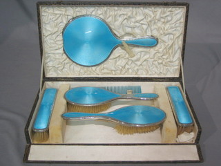 A silver and blue enamel 5 piece dressing table set  comprising hand mirror, pair of hair brushes, pair of clothes brushes cased (some damage to enamel)