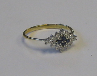 A gold dress ring set 4 sapphires supported by numerous diamonds