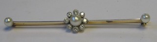 A lady's attractive gold bar brooch set 3 pearls supported by 8 diamonds