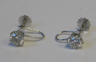 A pair of lady's 18ct gold solitaire diamond earrings with screw backs