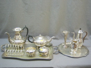 An oval twin handled silver plated tea tray, a circular silver plated salver, a toast rack, a silver plated specimen vase and a 3 piece silver plated tea service