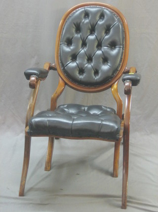 A 19th Century mahogany framed campaign chair upholstered in black buttoned material
