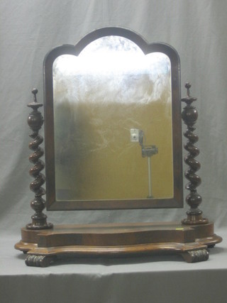 A Victorian arched plate dressing table mirror contained in a mahogany swing frame with spiral turned supports 27"