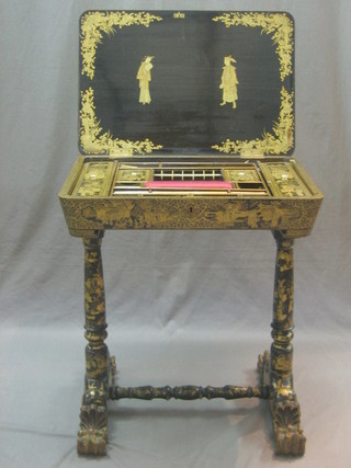 A 19th Century lacquered work box with hinged lid and various ivory fitments, raised on turned supports with paw feet 12"