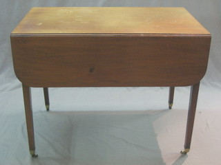 A 19th Century mahogany Pembroke table fitted a drawer raised on square tapering supports ending in brass caps and castors 36"