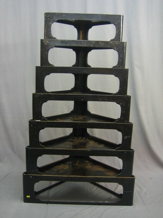 An Oriental triangular shaped nest of 7 interfitting tables 32"