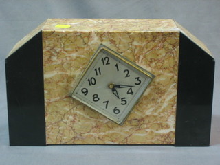 An Art Deco mantel clock with diamond shaped silvered dial contained in a black and white marble case