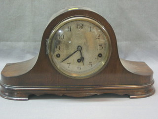 A chiming mantel clock with silvered dial and Arabic numerals contained in a mahogany Admiral's hat shaped case