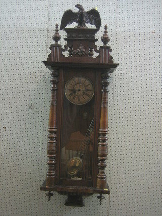A Vienna style regulator with paper dial, Roman numerals and grid iron pendulum contained in walnut case