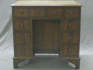 A Georgian style mahogany dressing table/desk with inset writing surface fitted 2 long drawers above 4 short drawers with cupboard to centre, raised on bracket feet 31"