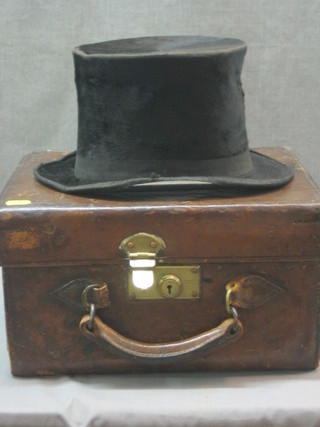 A gentleman's black top hat (somewhat tattered) contained in a leather box