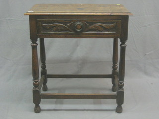 A Victorian carved oak side table  fitted a drawer raised on turned and block supports with box framed stretcher 27"
