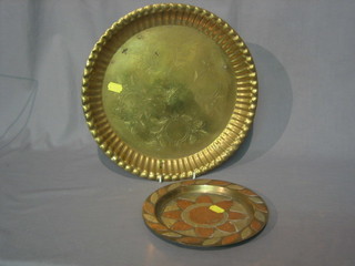 An Eastern copper and brass plate 8" and a brass plate 12"