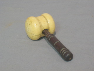 A turned ivory gavel with turned wooden handle