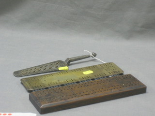 A 19th Century triangular shaped polished steel drill sizer together with a brass cribbage board and a wooden do.