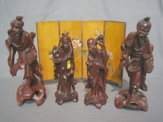 A pair of Eastern carved wooden figures of Sages 8" together with a 4 fold carved wooden table screen