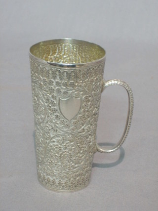 An Eastern embossed silver spirit measure with engraved decoration  2 ozs