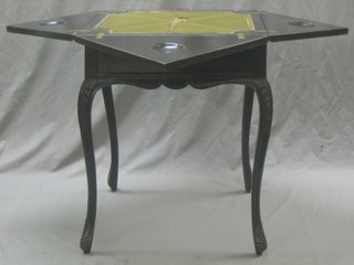 An Edwardian ebonised envelope card table, the base fitted a drawer, raised on cabriole supports 22"