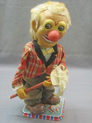 A Rosko tin plate model of a clown with duster