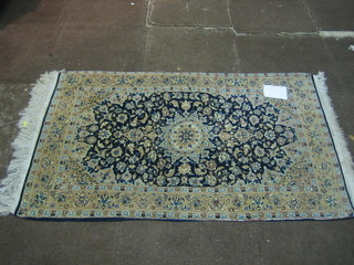 A fine quality 20th Century blue ground and floral patterned Persian rug with medallion to the centre within floral borders 51" x 31"