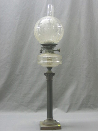 A 19th Century glass oil lamp with etched glass shade, raised on a reeded brass column with Corinthian capital