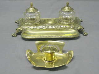 An Art Nouveau pierced brass inkwell complete with ceramic liner 5" and a Victorian brass 2 bottle inkwell with pen receptical raised on paw feet 9 1/2"