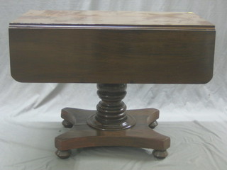 A 19th Century mahogany pedestal Pembroke table raised on  a turned column with triform base 39"
