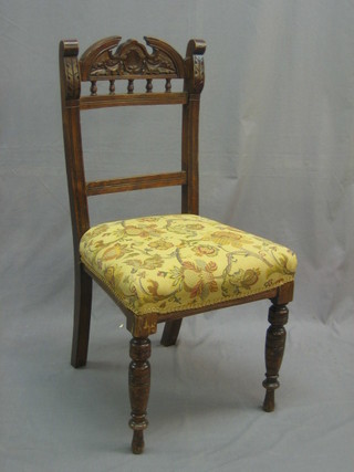 A set of 4 Edwardian carved walnut bar back dining chairs with bobbin turned decoration and upholstered seats
