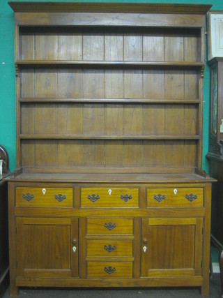 A 19th/20th Century Georgian style oak dresser the raised back fitted a drawer with cornice and 3 shelves, the base fitted 3 short drawers above 3 long drawers, flanked by a pair of cupboards 60"