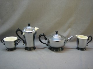 An Art Deco ceramic and chromium plated 4 piece tea service with teapot, hotwater jug, cream jug and twin handled sugar bowl