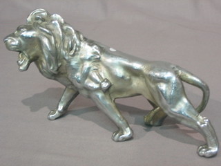 A white metal figure of a walking lion 9"