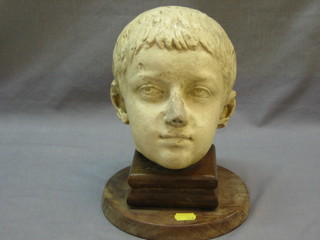 A 1920's bust - head portrait of a young boy 9", raised on an oak stand 