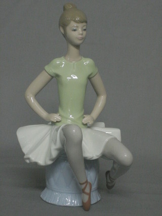 A Lladro figure of a seated Ballerina, the base marked 1360 10"