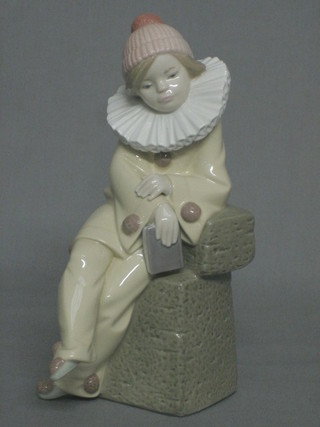 A Lladro figure of a seated clown, the base marked 5203 8"