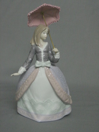 A Lladro figure of a standing lady with parasol, base impressed 5211 9"