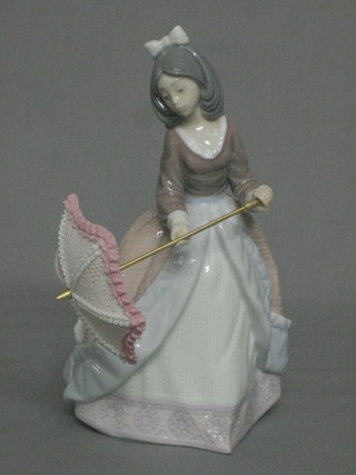 A Lladro figure of a lady with parasol, the base marked 5210 8"
