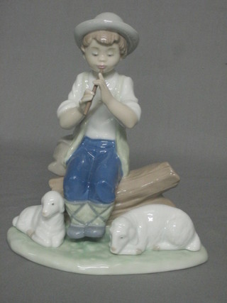 A Nao figure of a seated shepherd with pipe and 2 sheep 7"