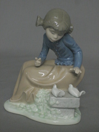 A Nao figure of a seated girl with 2 doves 6"