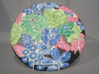 A Clarice Cliff pierced pottery wall plaque of floral form, with painted Clarice Cliff signature to the front, the reverse marked Bizarre by Clarice Cliff  13" diameter
