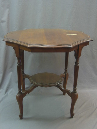 An Edwardian circular mahogany 2 tier occasional table raised on a reeded column and cabriole supports, 30"