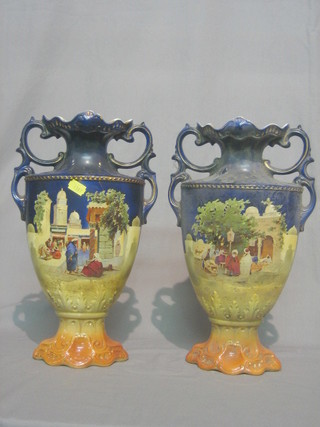 A pair of Edwardian black glazed twin handled pottery vases decorated a market scene 14"