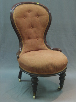 A Victorian mahogany show frame spoon back chair upholstered in pink material, raised on turned and reeded supports