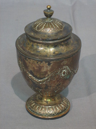 A Georgian style Victorian embossed silver caddy of urn form raised on a circular spreading foot 7"