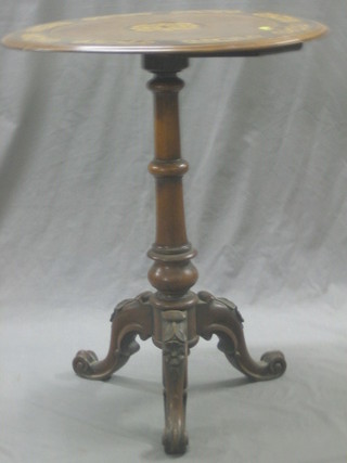 A Victorian circular amboyna wood wine table, the top heavily inlaid, raised on a carved column, tripod and base 24"